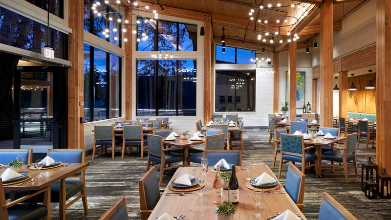 Bright dining room with tables set for meals