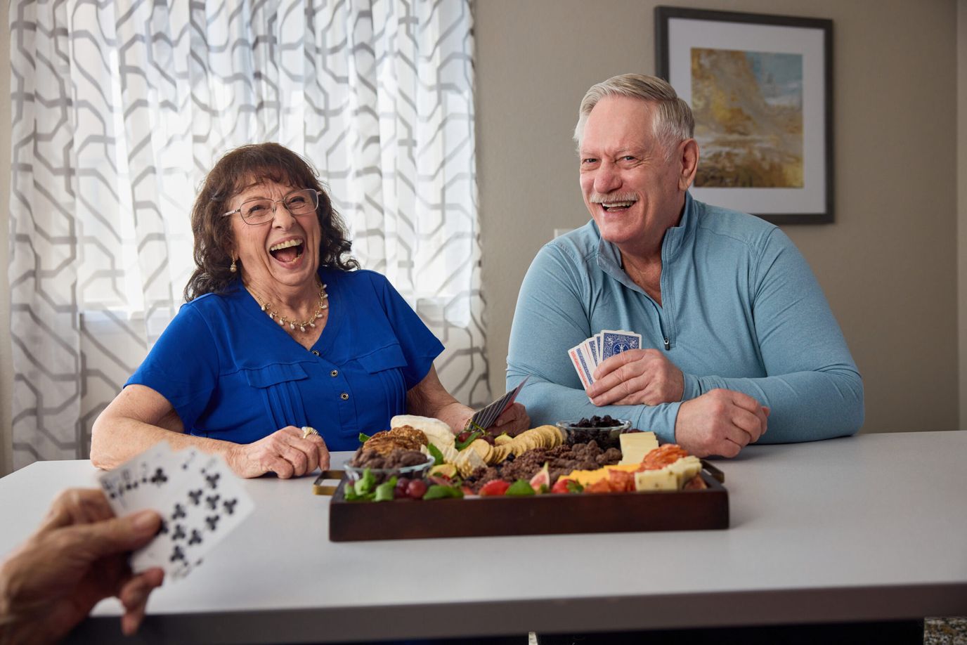 Orchard Pointe by Cogir, memory care in Port Orchard, WA — Seniors enjoying snacks and playing cards together
