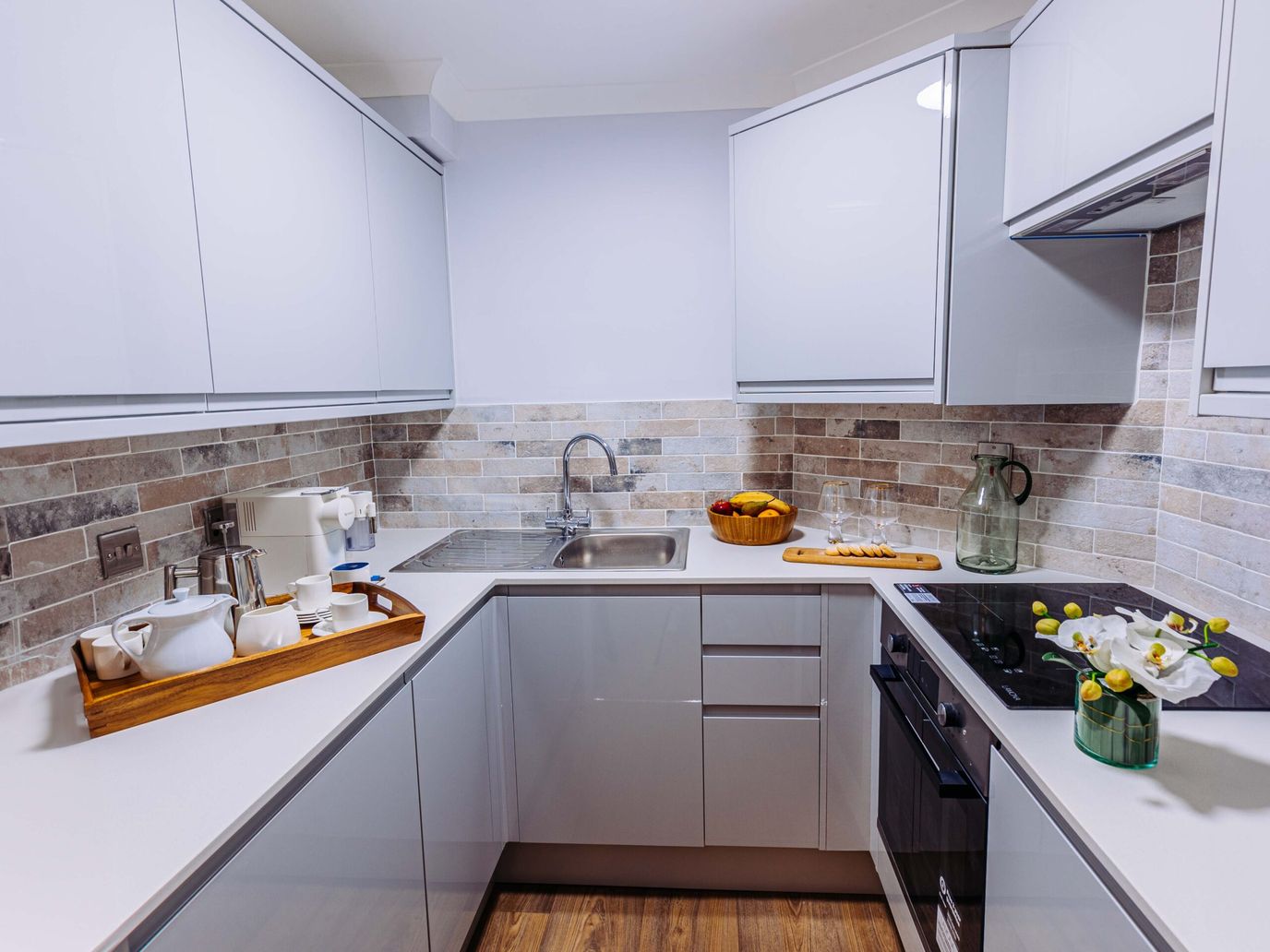Modern kitchen with sleek cabinets and a tray.