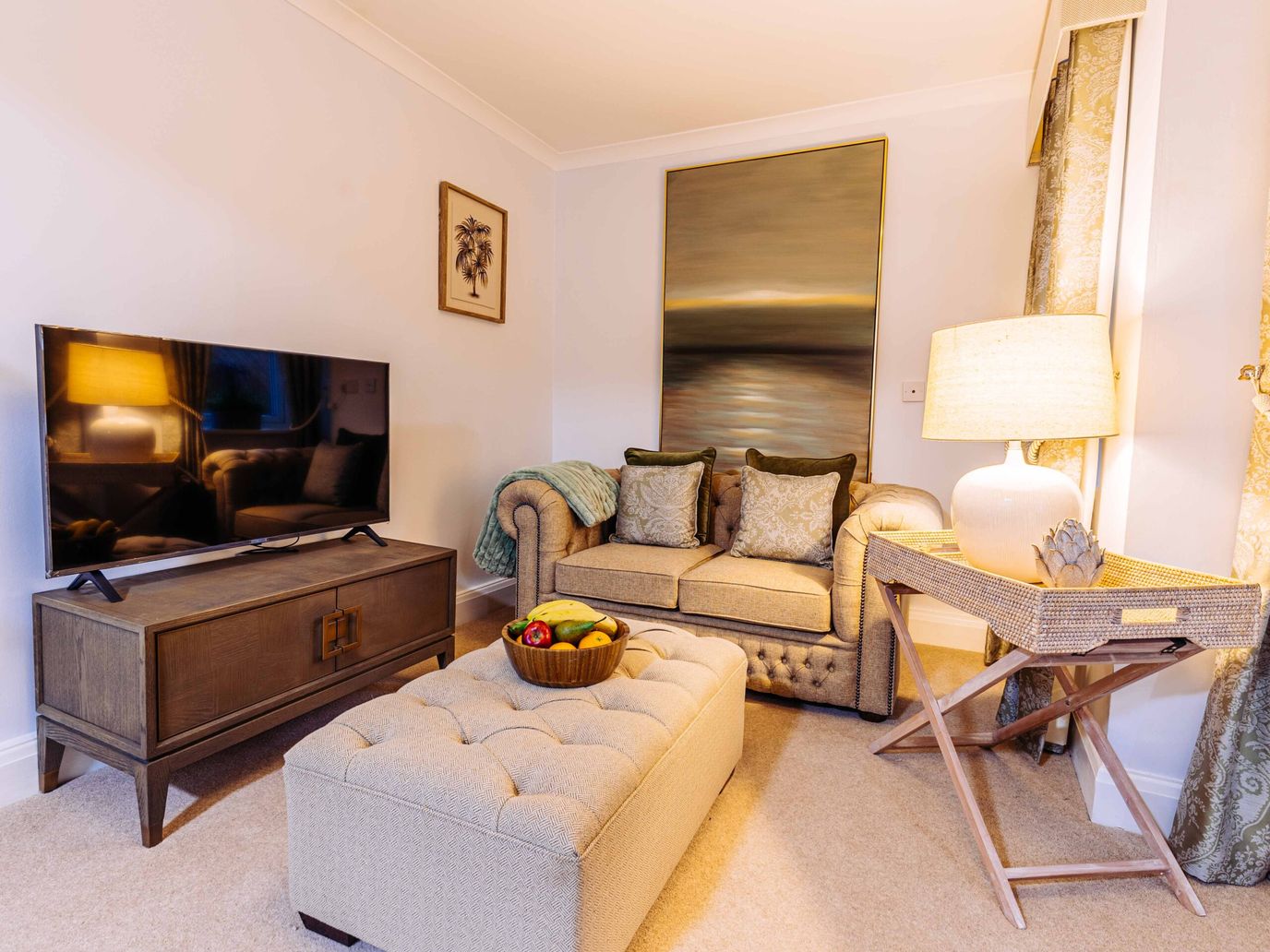 Cozy common area with a sofa, TV, and decor.