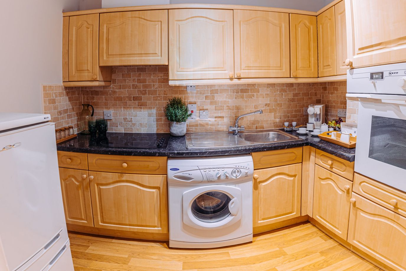 Compact kitchen area with wooden cabinets