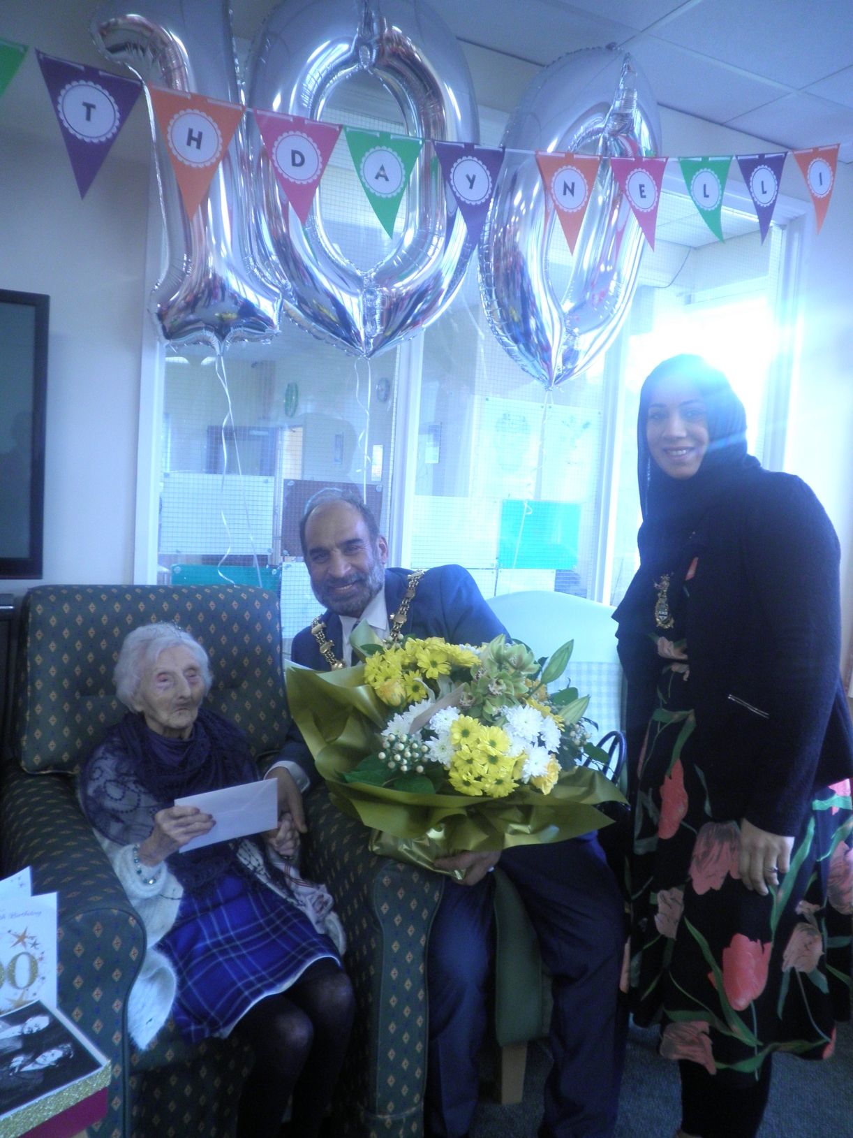 Celebration with balloons and flowers in a common area