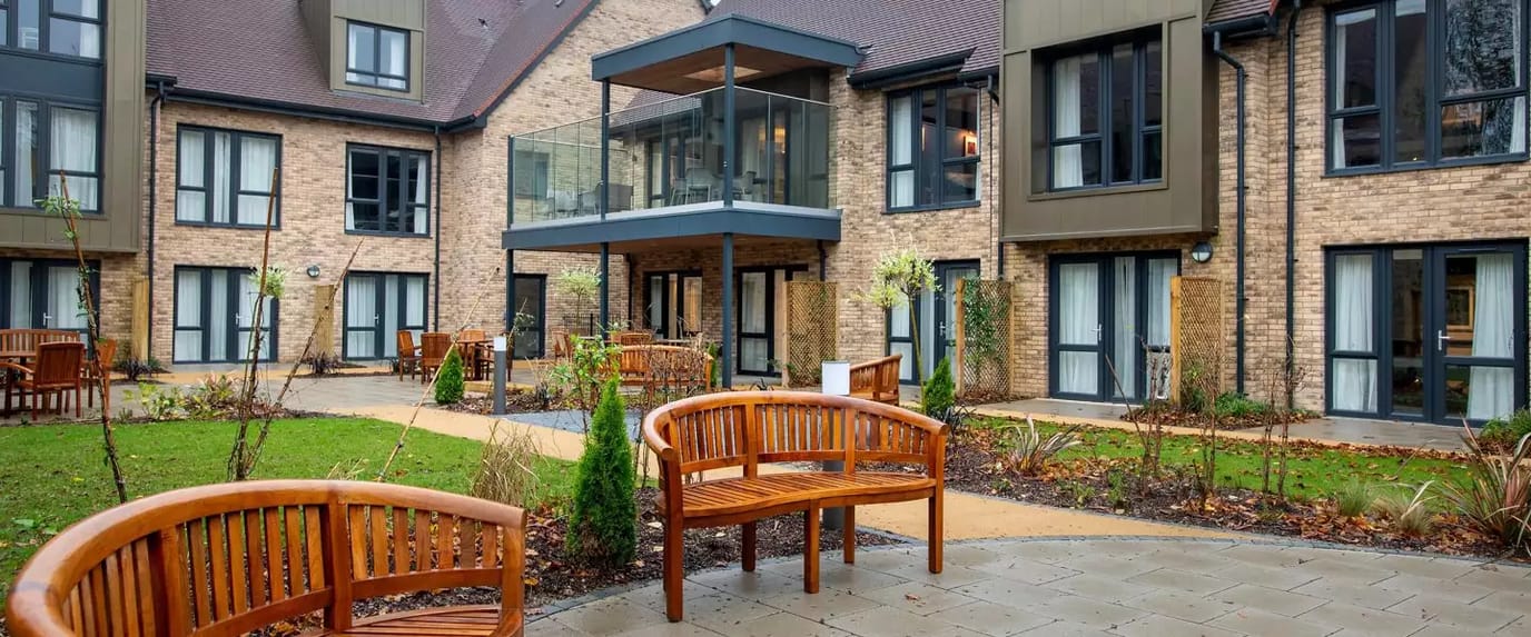 Outdoor seating area with benches and landscaping.