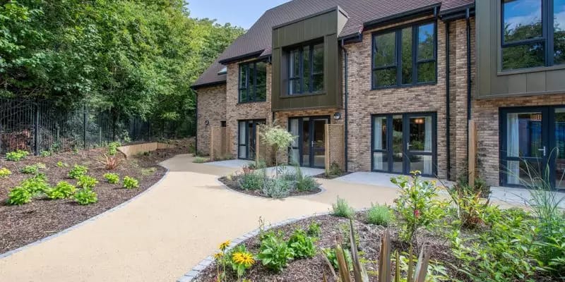 Exterior view of the building with landscaped garden.