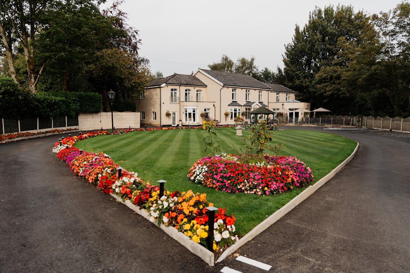 Beautifully landscaped outdoor area with colorful flowers and building