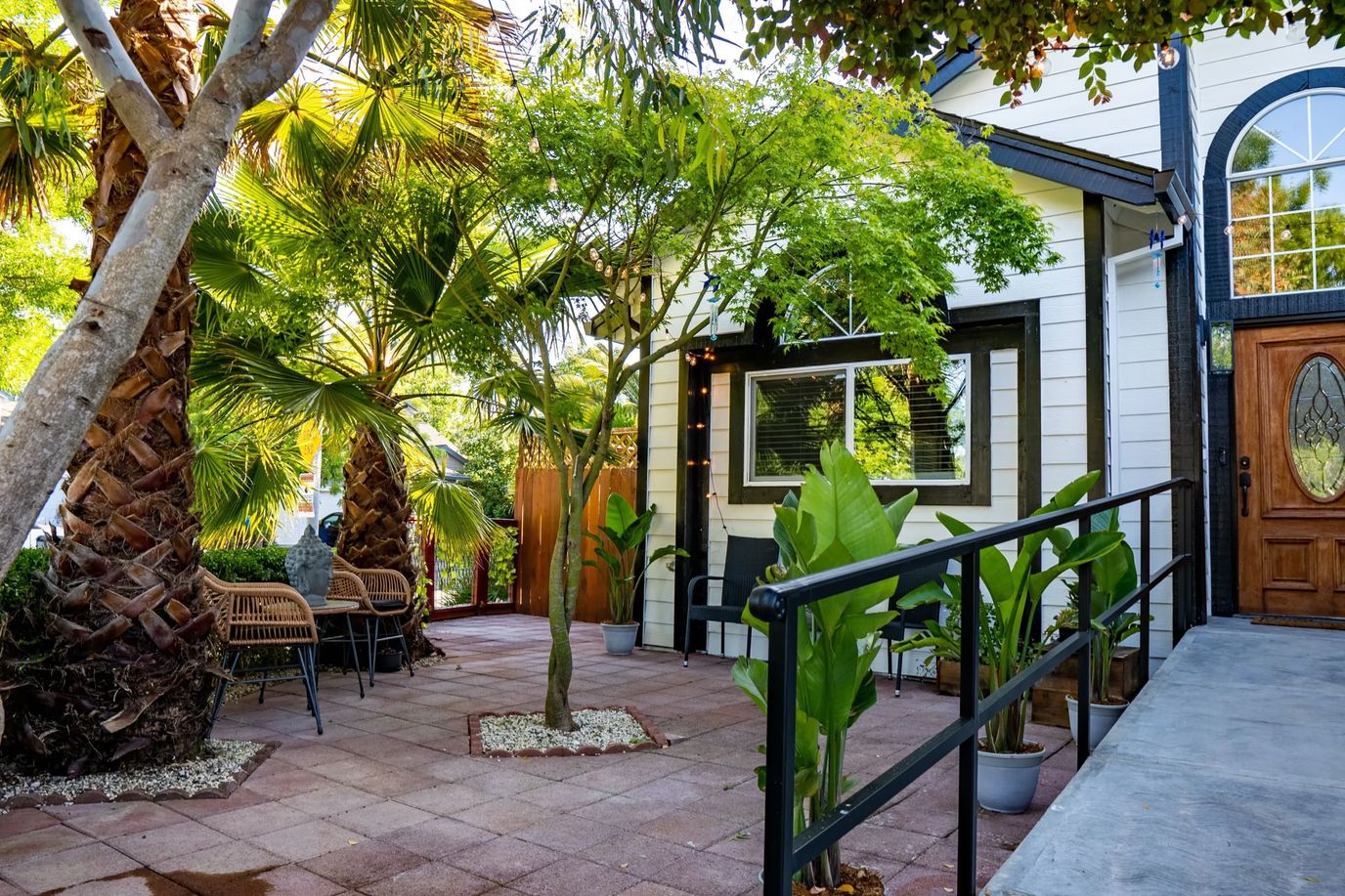 Exterior view of a patio area with palm trees