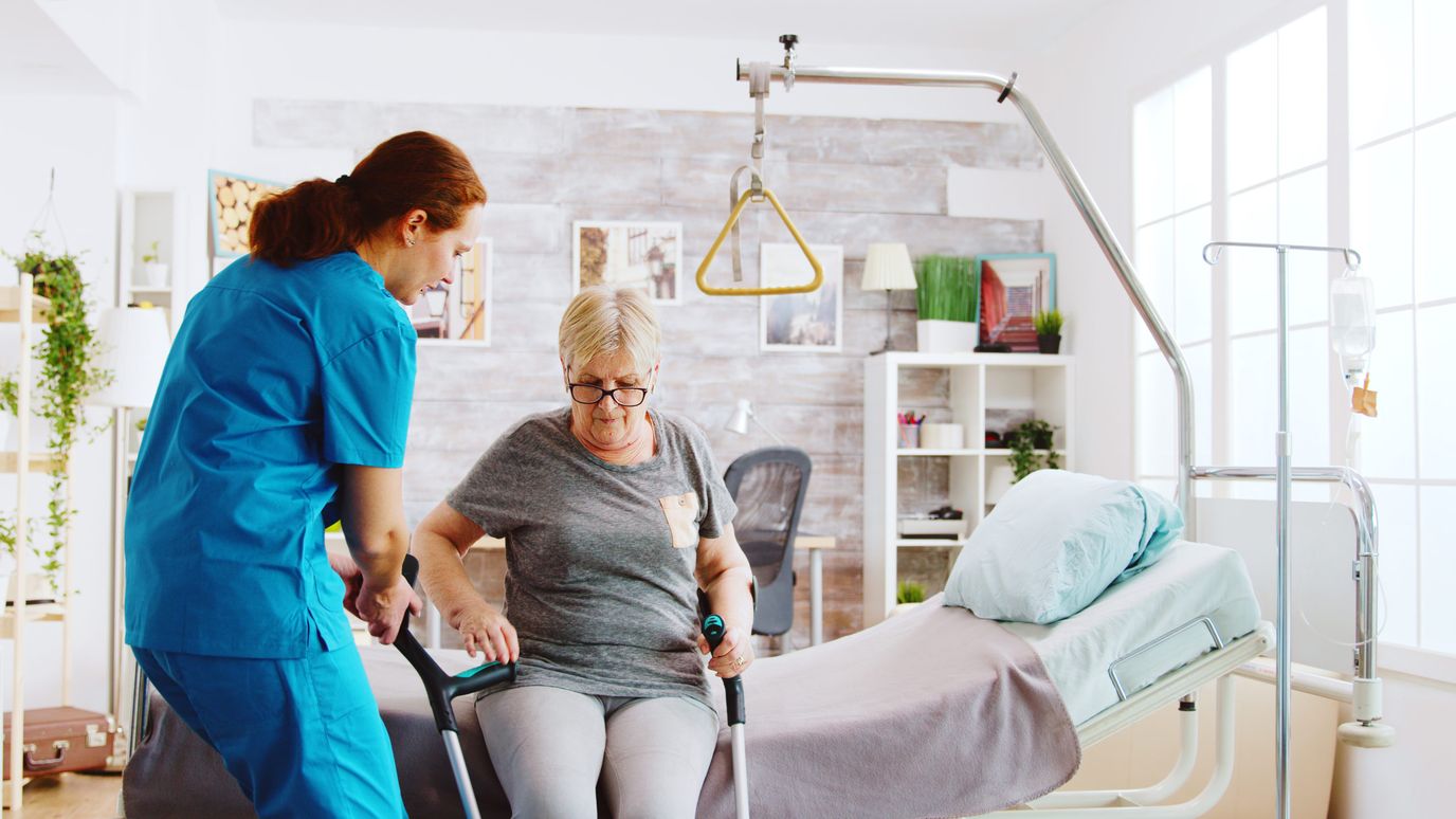 Care staff assisting a resident in a healthcare setting