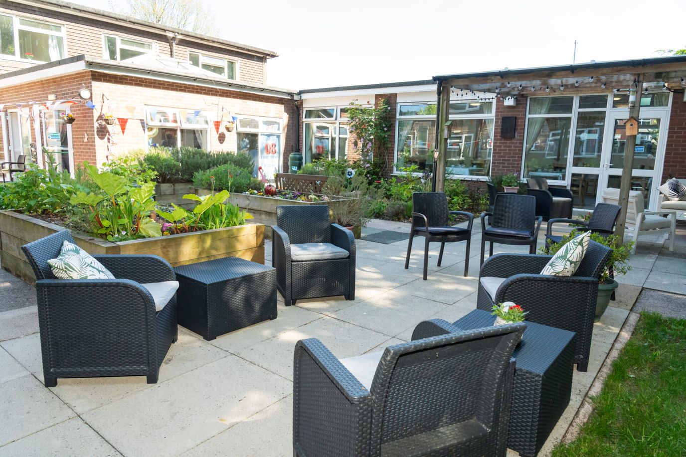 Outdoor seating area with plants and chairs