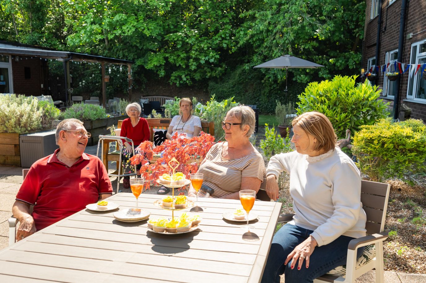Residents enjoying outdoor drinks and conversation.