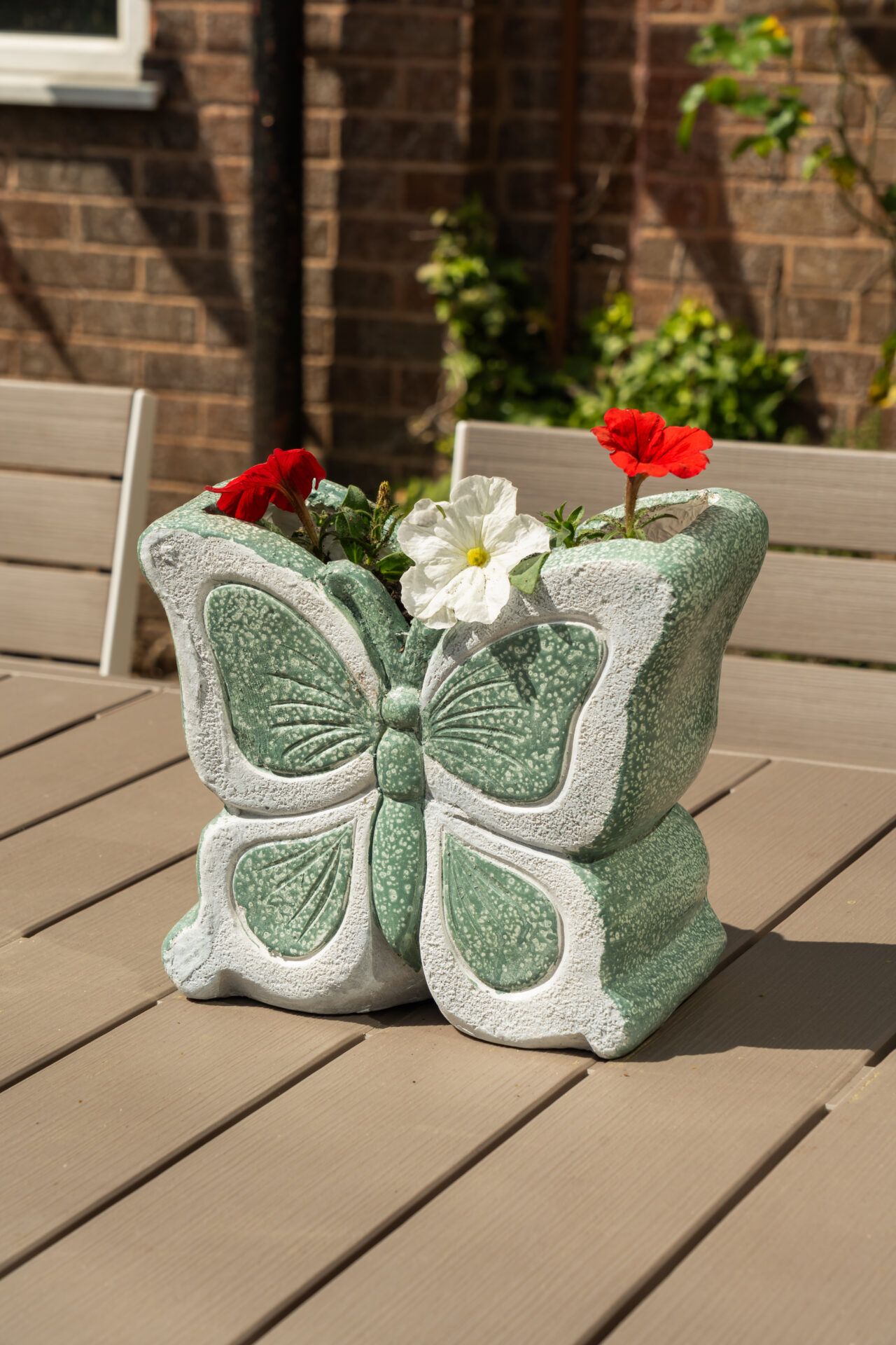 Butterfly planter with flowers on a table