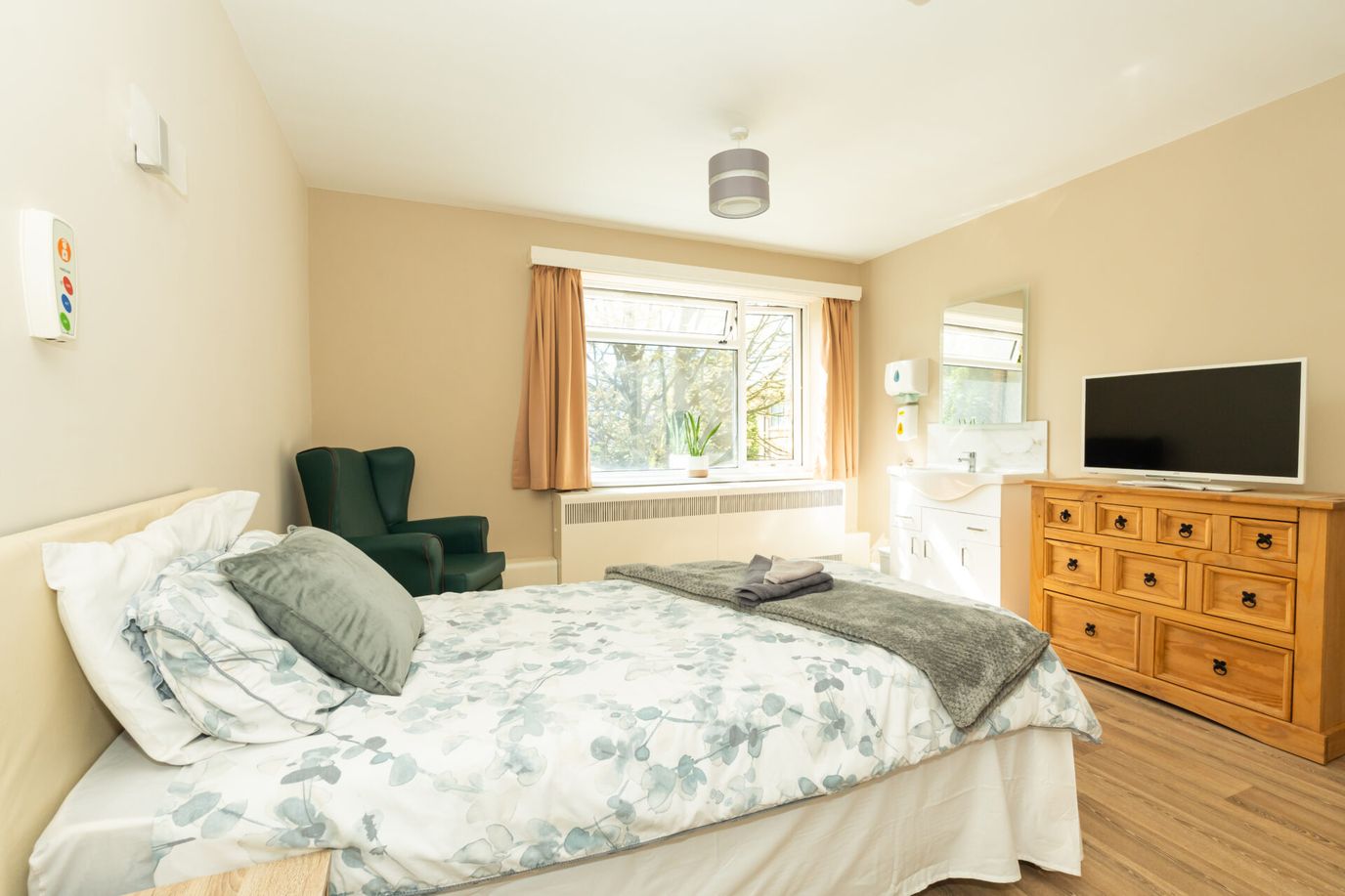 Comfortable resident room with bed and TV