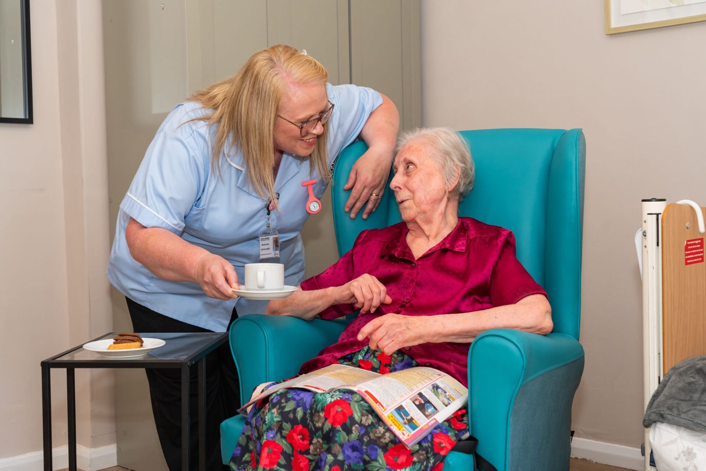 Caregiver interacting with a resident in a cozy room