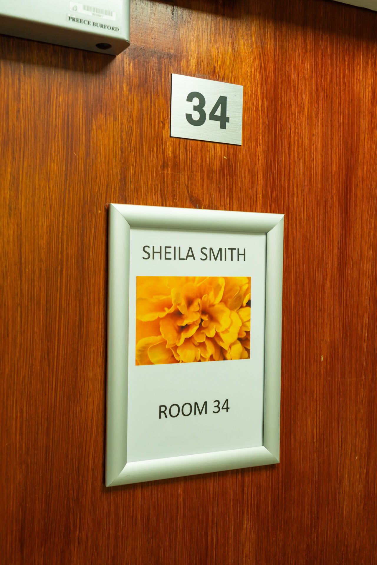 Room number sign with a floral design