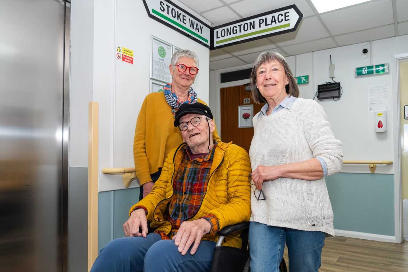 Residents and staff in a common area of the facility.