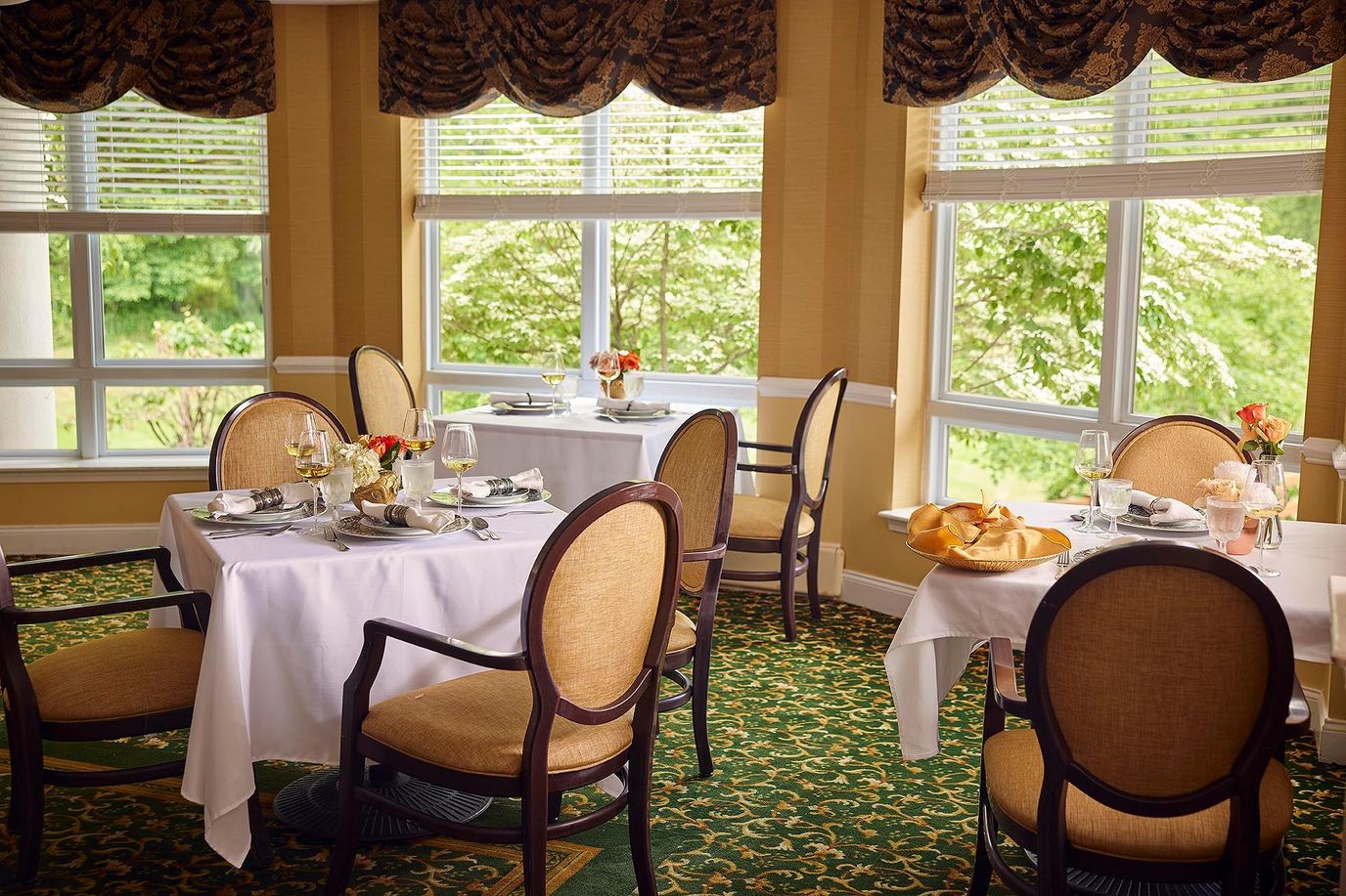 Cozy dining room with elegantly set tables and natural light
