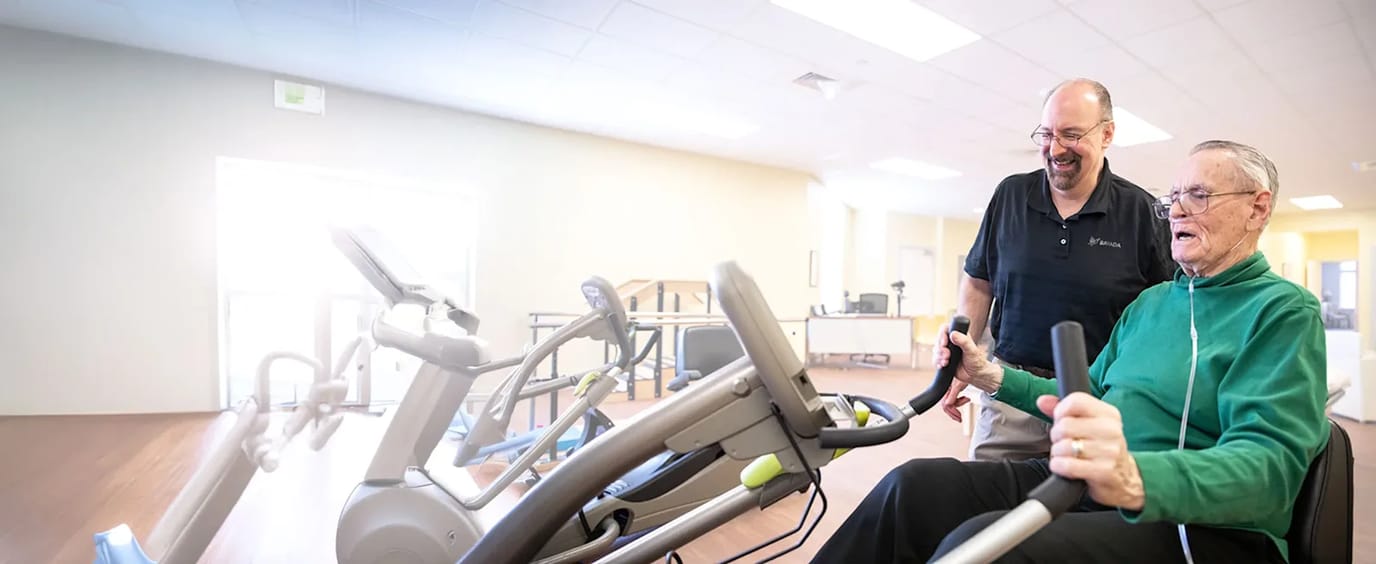 Resident engaging in physical activity with staff guidance