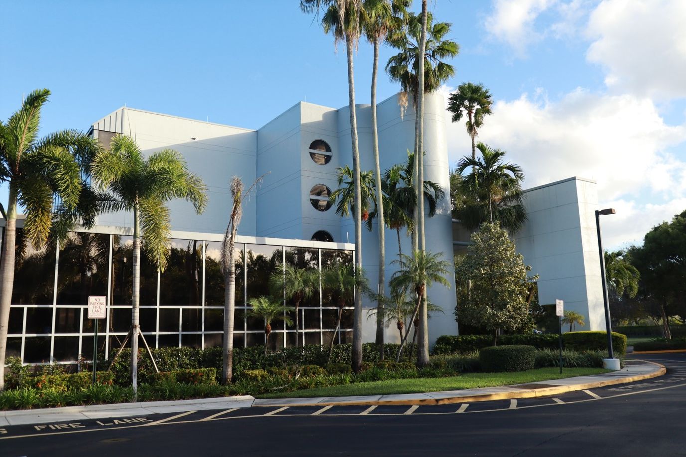 Exterior view of Avalina Senior Living building with palm trees