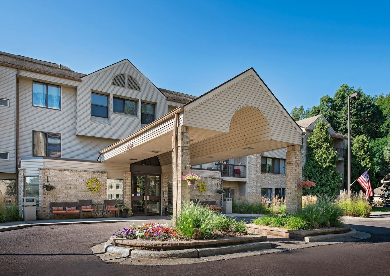 Front entrance of American House Carpenter facility with landscaping