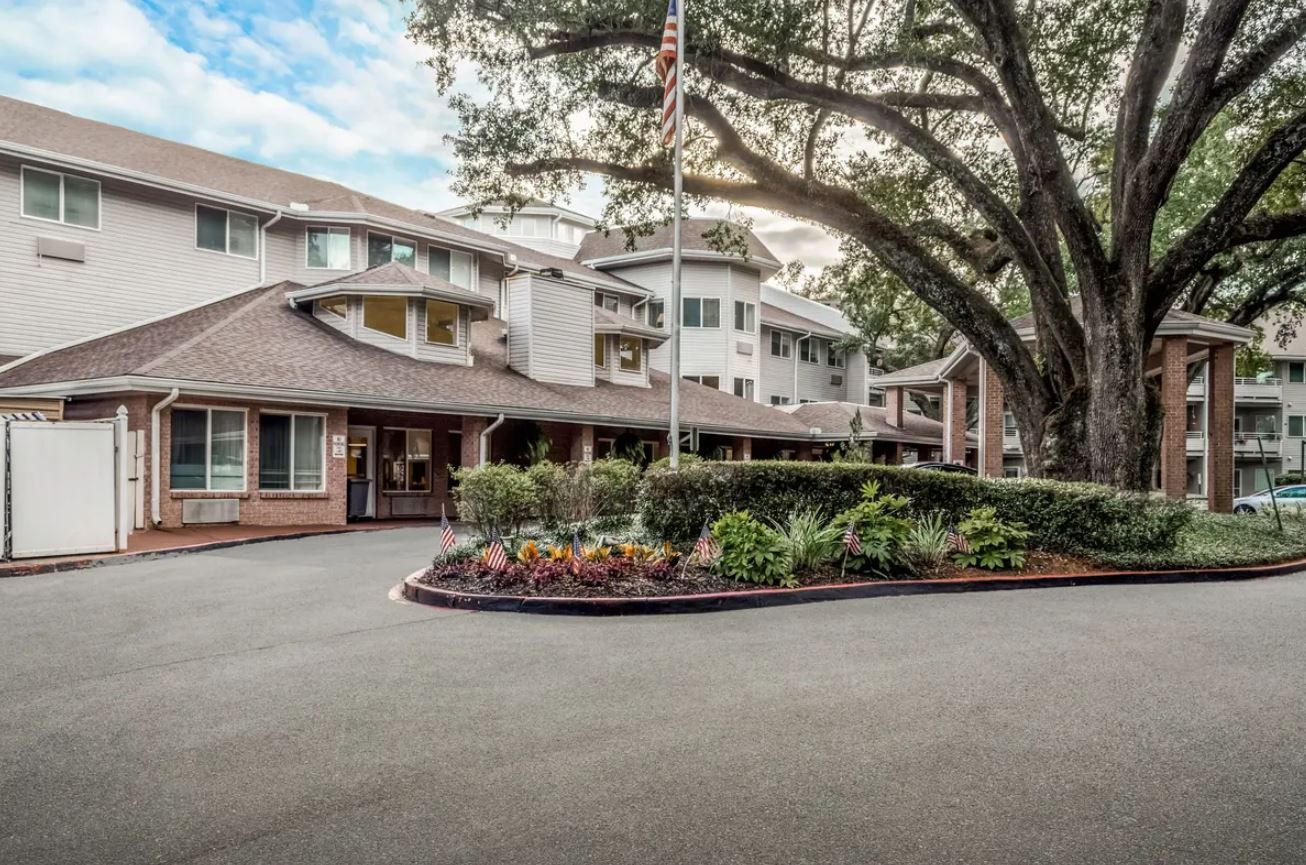 Entrance of Asher Point Independent Living with landscaped grounds