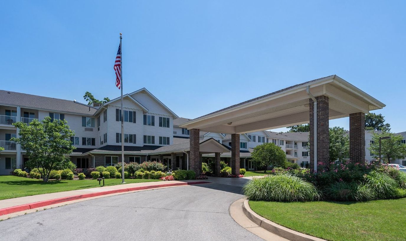 Building exterior with landscaped entrance and driveway