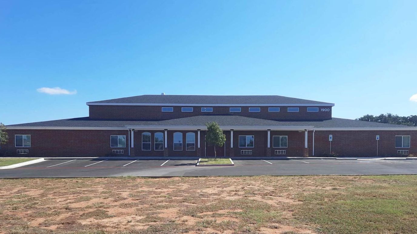 Exterior view of BeeHive Homes building with parking lot