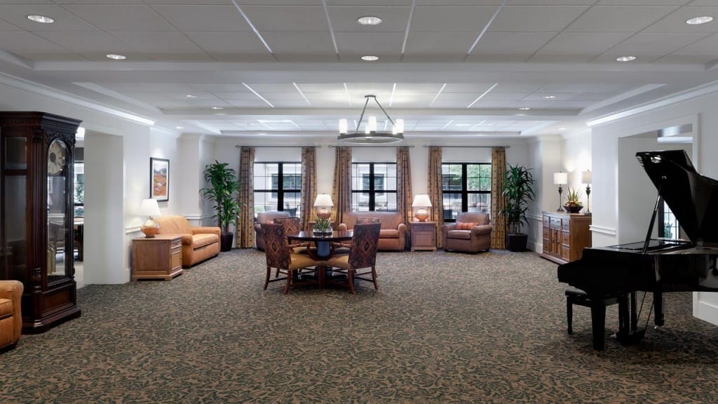 Bright common area with seating and piano