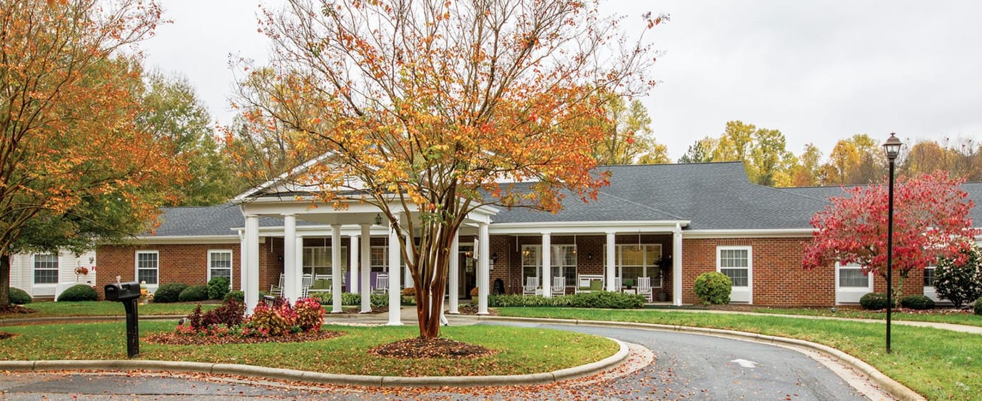 Exterior view of Brookdale Northwest Greensboro with autumn foliage