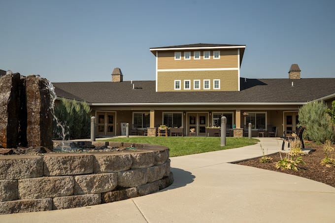 Outdoor view of a senior living facility with a fountain