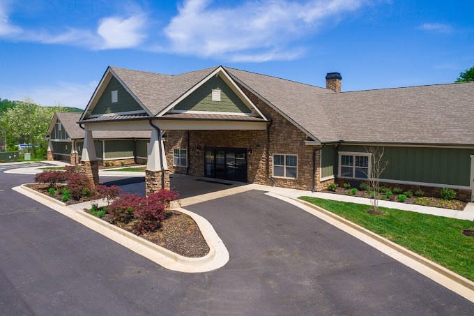 Exterior view of a senior living facility with gardens
