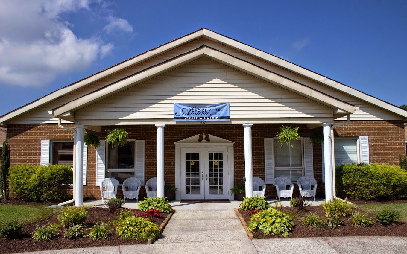 Front entrance of Dominion Village at Poquoson with ample greenery