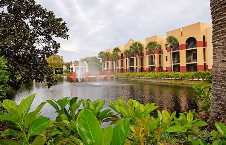 Exterior view of the facility by a tranquil pond
