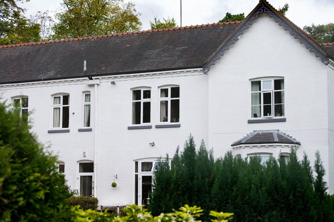 Exterior view of Grove House with green shrubbery