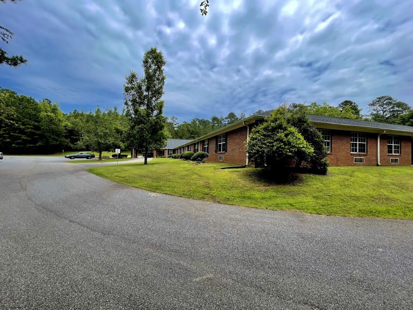 Exterior view of the facility with gardens and pathways