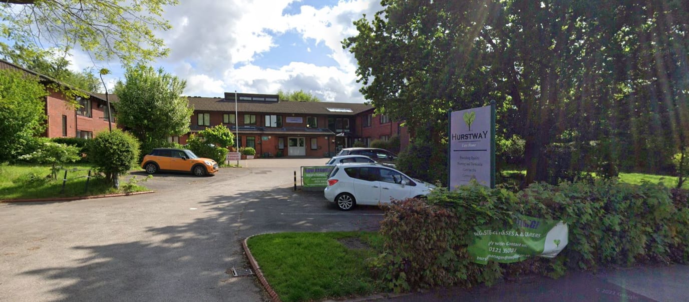 Exterior view of Hurstway Care Home with green landscaping
