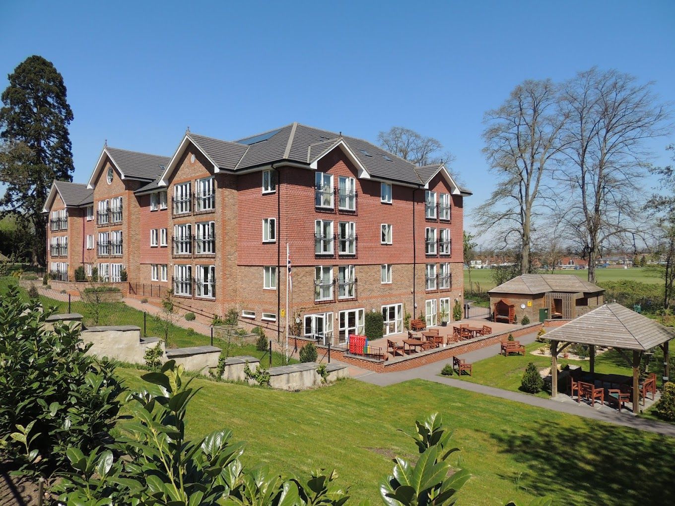 Exterior view of Lakeside Care Home with landscaped gardens