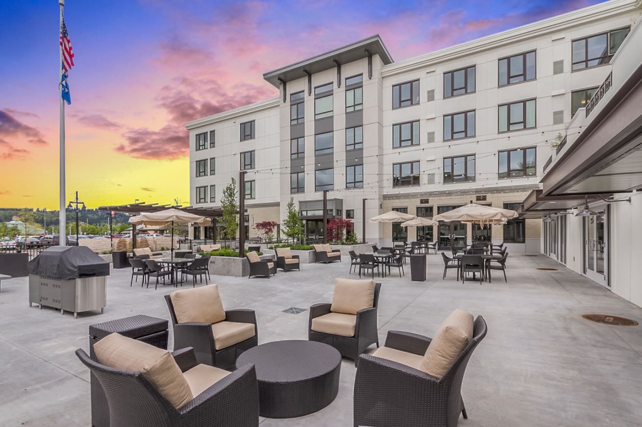 Outdoor seating area at Merrill Gardens with sunset