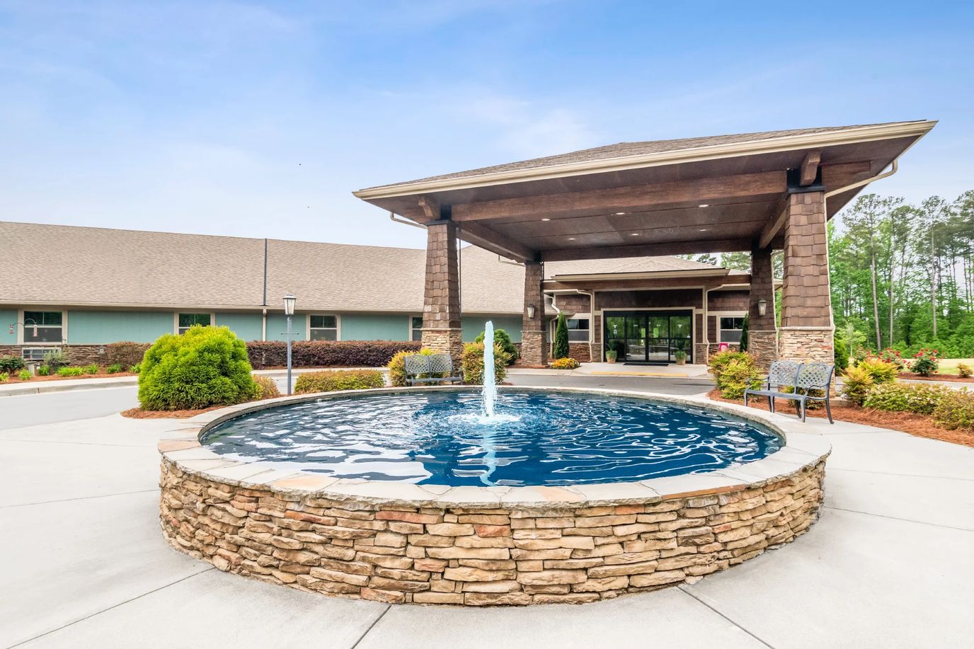 Exterior view of a facility entrance with a fountain