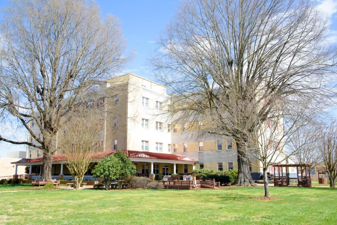 Exterior view of Peachtree Centre with trees and outdoor seating