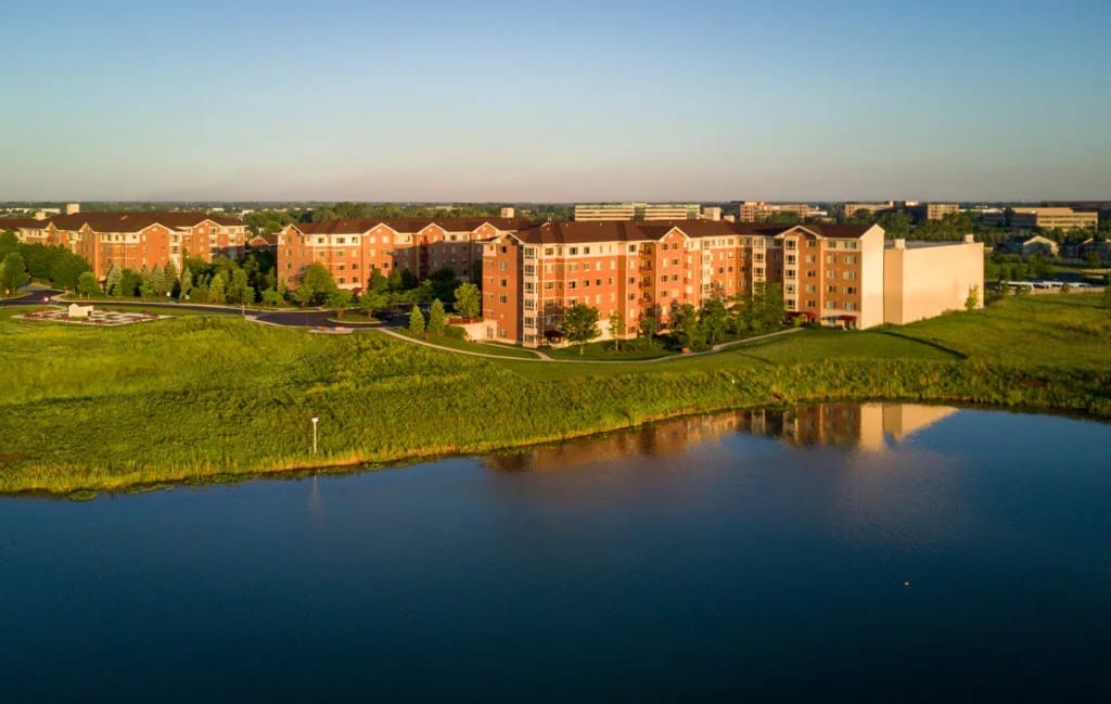 Aerial view of a senior living facility by a lake