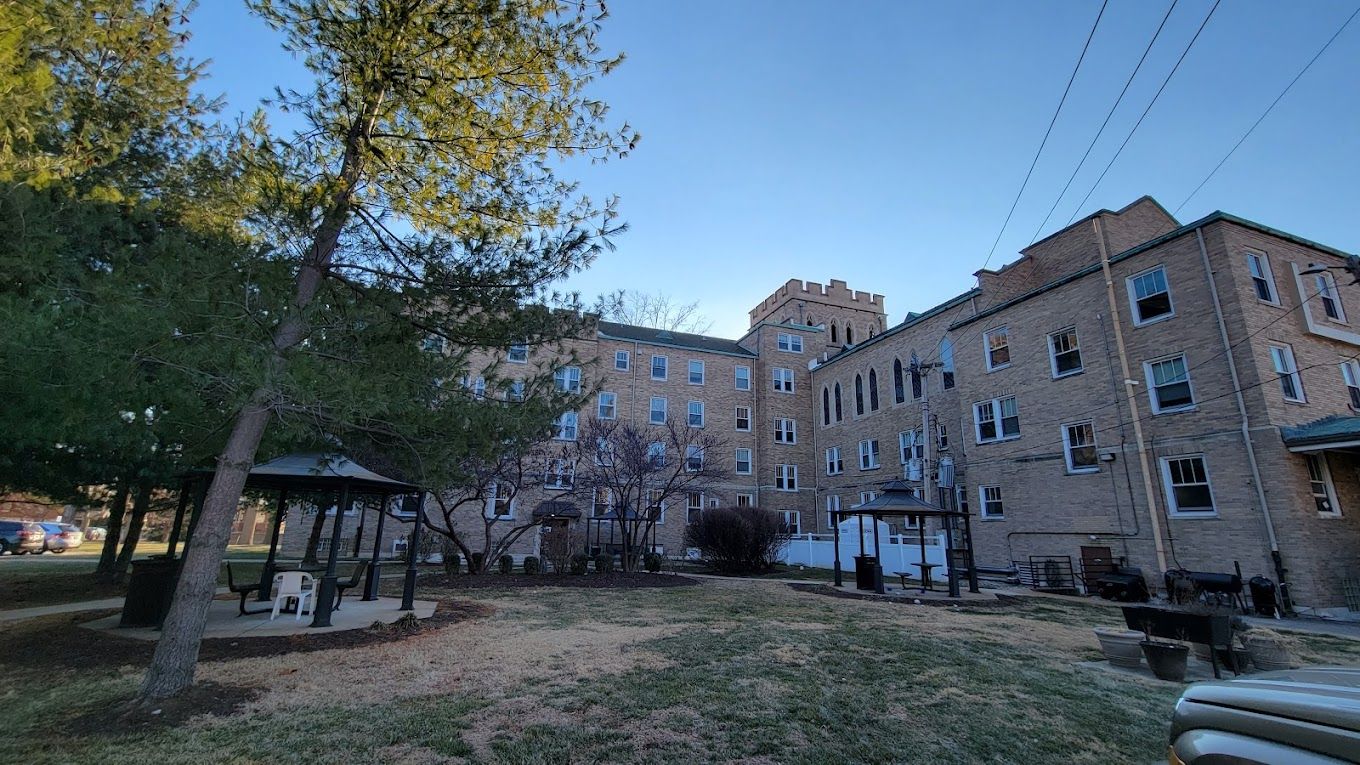 Exterior view of St. Elizabeth Hall with outdoor seating area
