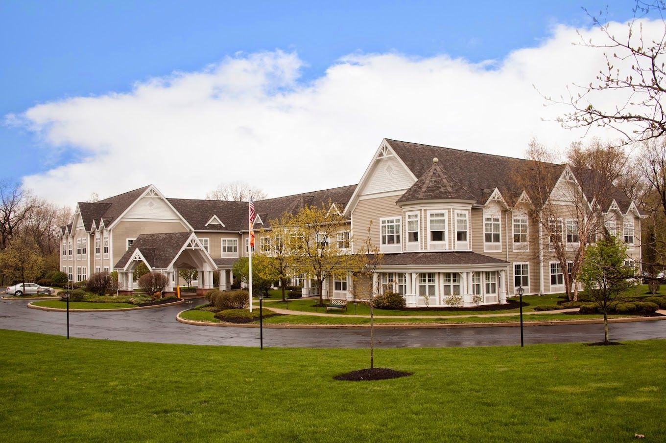 Exterior view of a senior living facility with landscaped grounds