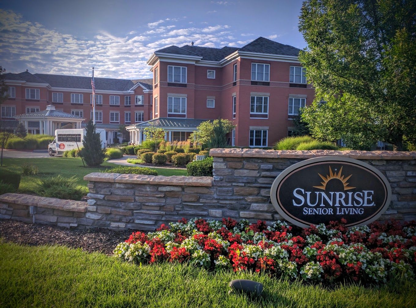 Exterior view of Sunrise Senior Living with landscaped gardens