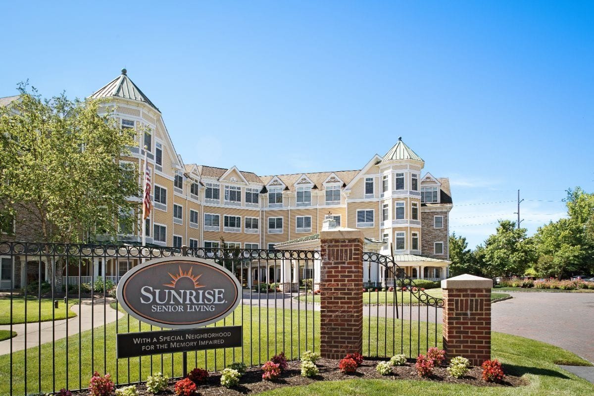 Exterior view of Sunrise Senior Living with logo