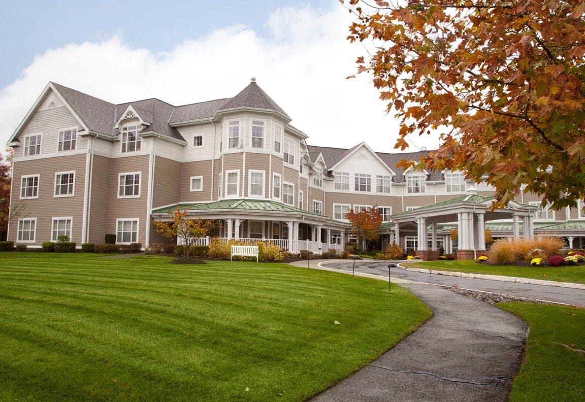 Building exterior of Sunrise of New City with lawn