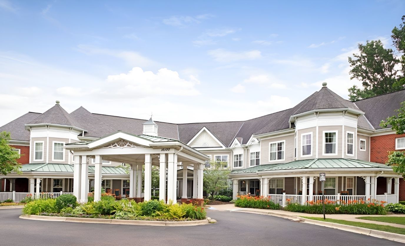 Exterior view of a senior living facility with gardens