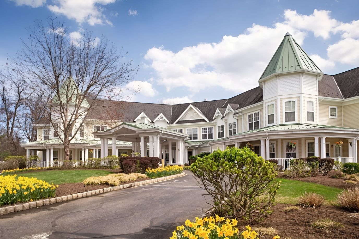 Exterior view of a senior living facility with blooming flowers