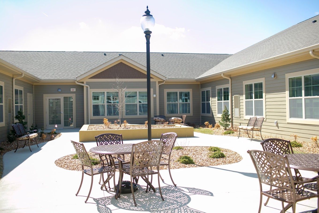 A serene outdoor courtyard with tables and chairs