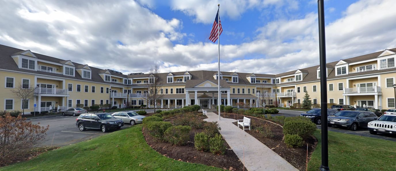 Exterior view of The Commons in Lincoln with gardens and parking