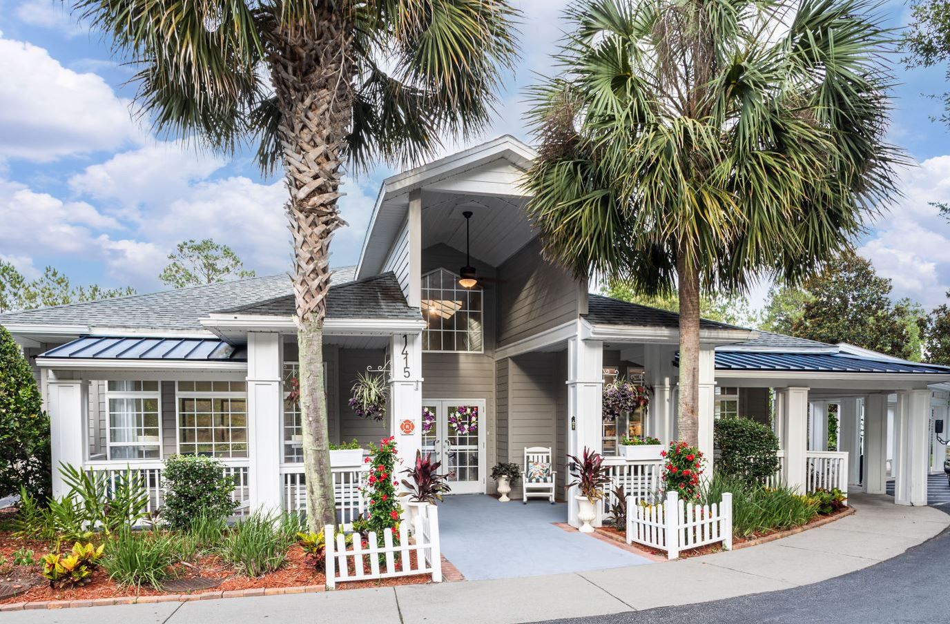 Front entrance of The Gables of Gainesville with palm trees