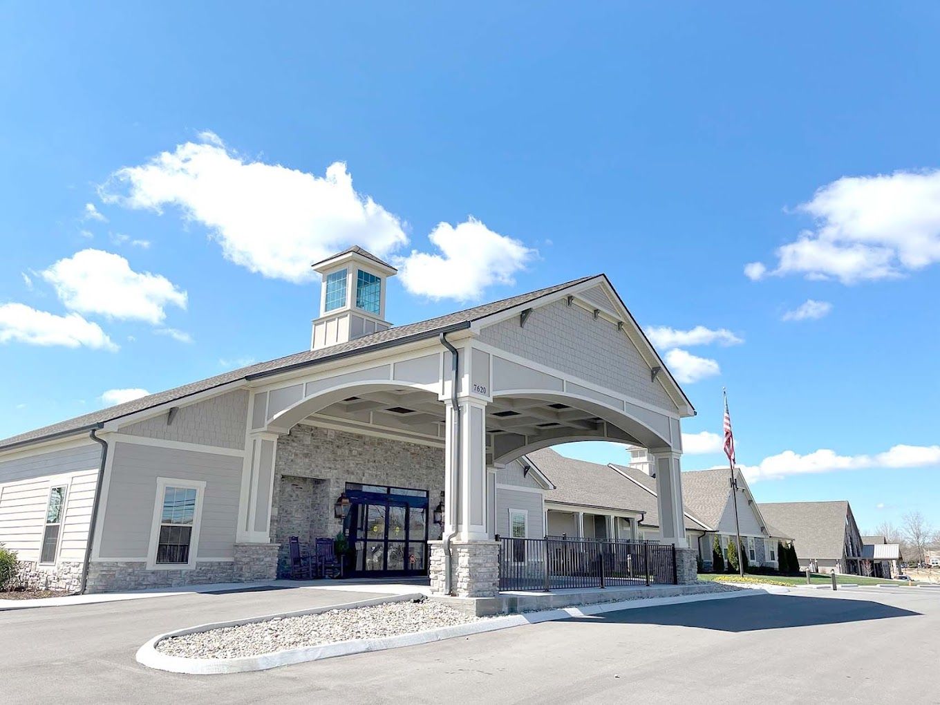 Exterior view of a senior living facility with a covered entrance
